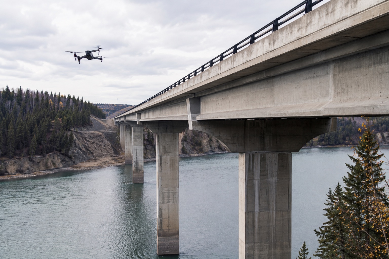 Drone inspecting a concrete bridge over a Canadian river